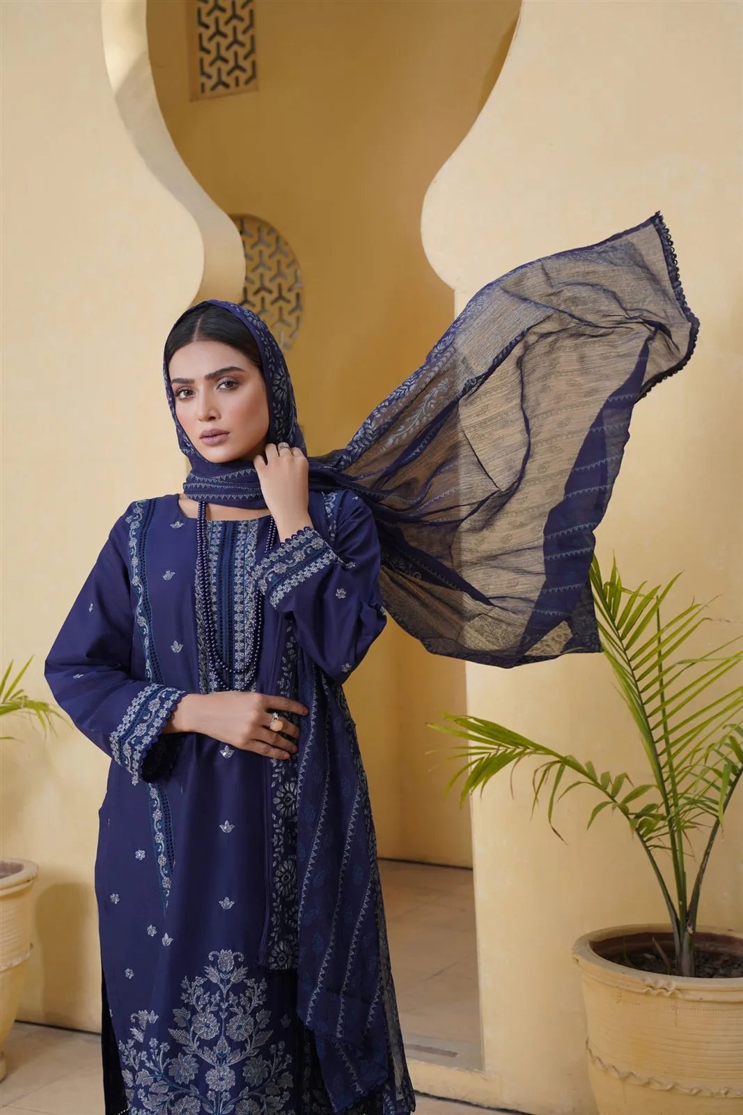 Woman wearing a navy embroidered three-piece