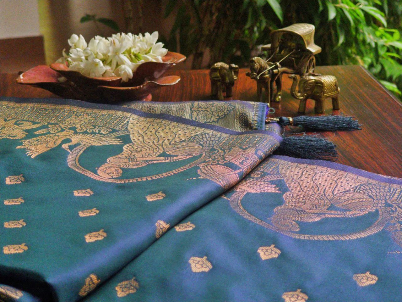 Woman in a peacock blue Katan silk saree