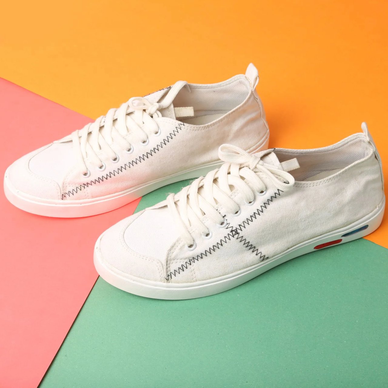 Pair of white low-top canvas sneakers